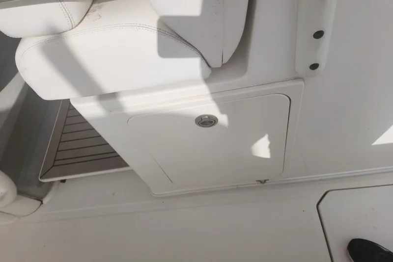 Slide: The Image of 2014 Boston Whaler 350 Outrage interior detail with white seating and storage compartment. - 28
