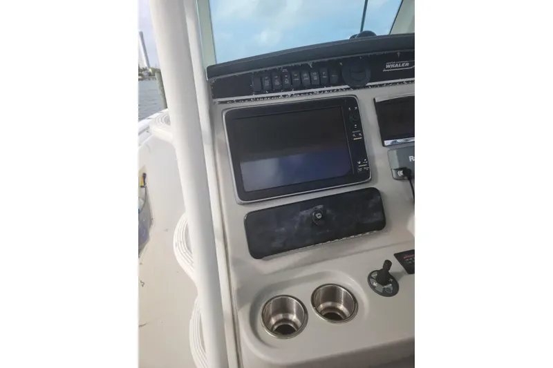Slide: The Image of Control panel of a 2014 Boston Whaler 350 Outrage boat with navigation equipment. - 29