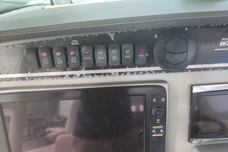 Slide: The Image of Control panel of a 2014 Boston Whaler 350 Outrage boat with various switches. - 30