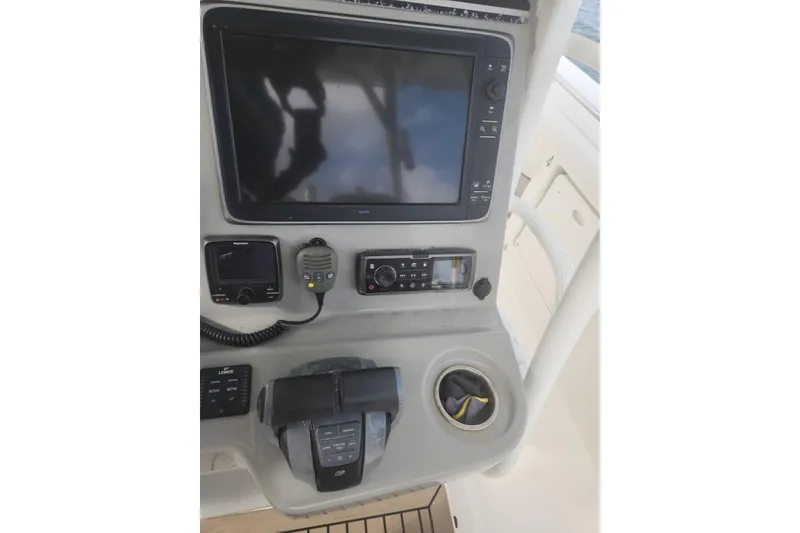 Slide: The Image of Control panel of a 2014 Boston Whaler 350 Outrage boat with navigation equipment. - 32