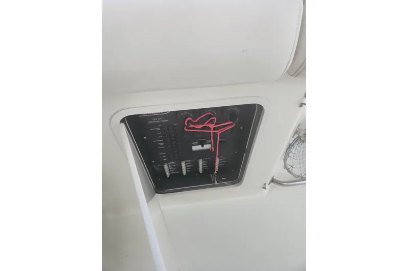 Slide: The Image of Electrical panel on a 2014 Boston Whaler 350 Outrage boat, featuring wiring and switches. - 35