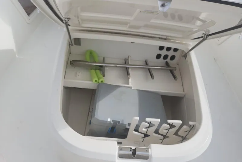 Slide: The Image of Open storage compartment on a 2014 Boston Whaler 350 Outrage boat. - 38