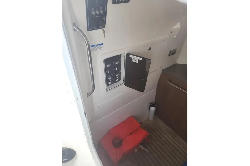 Slide: The Image of Interior of a 2014 Boston Whaler 350 Outrage boat with control panel and safety equipment. - 41