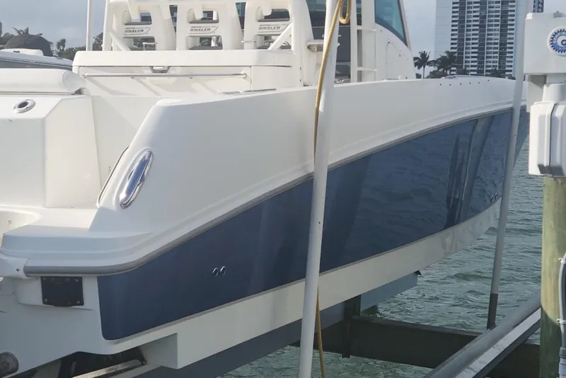 Slide: The Image of 2014 Boston Whaler 350 Outrage boat docked, showcasing sleek design and modern features. - 47