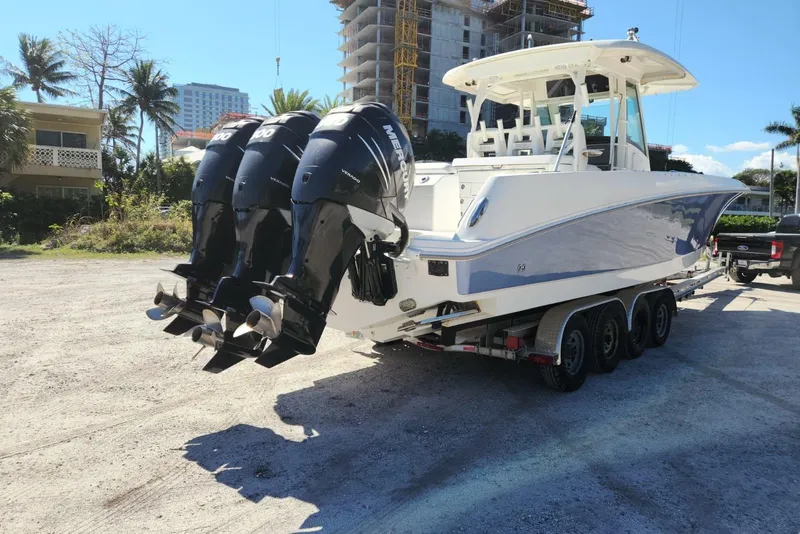 Slide: The Image of 2014 Boston Whaler 350 Outrage boat with triple Mercury engines on a trailer. - 5