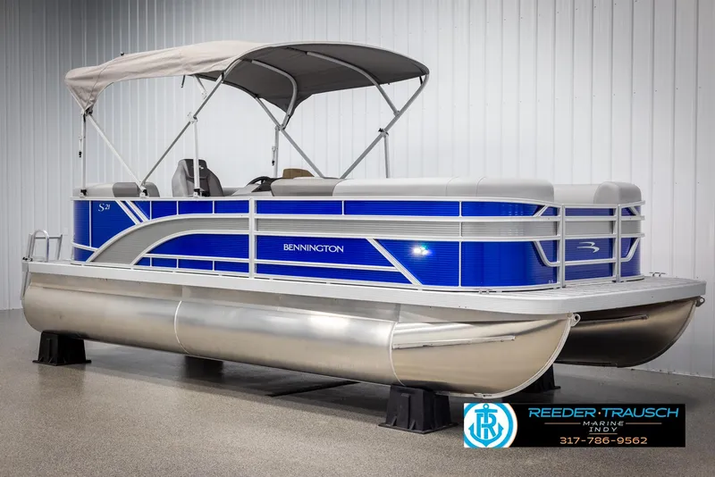 Slide: The Image of 2025 Bennington 21 SSR pontoon boat with blue design and canopy. - 2