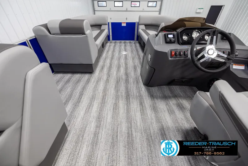 Slide: The Image of Interior of 2025 Bennington 21 SSR with gray seating and steering wheel. - 21