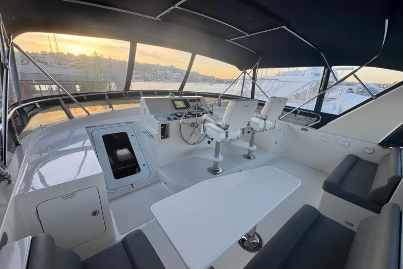 Slide: The Image of Luxurious 2007 Symbol 59' Pilothouse Classic yacht interior with helm and seating area. - 11