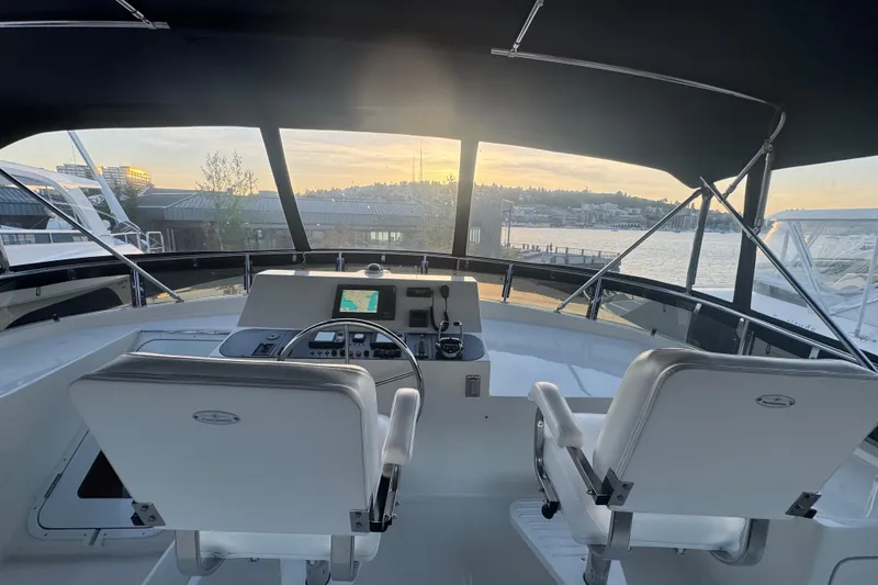 Slide: The Image of Pilothouse view of 2007 Symbol 59' Pilothouse Classic yacht at sunset, overlooking marina. - 13