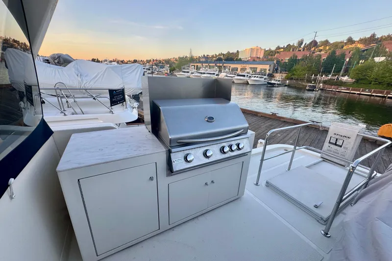 Slide: The Image of Outdoor grill on 2007 Symbol 59' Pilothouse Classic yacht, docked by scenic waterfront. - 15