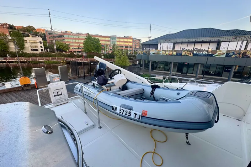 Slide: The Image of 2007 Symbol 59' Pilothouse Classic yacht with inflatable boat docked at marina. - 16