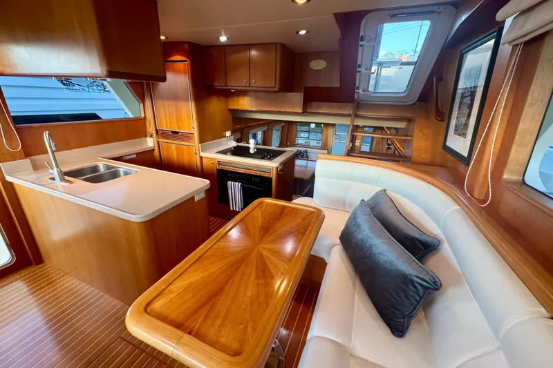 Slide: The Image of Luxurious interior of 2007 Symbol 59' Pilothouse Classic yacht with modern kitchen and seating area. - 19