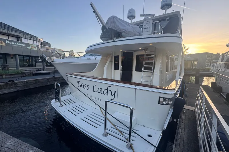 Slide: The Image of 2007 Symbol 59' Pilothouse Classic yacht docked at sunset, labeled "Boss Lady." - 2
