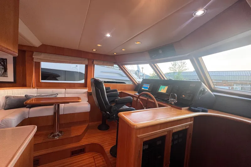 Slide: The Image of Luxurious 2007 Symbol 59' Pilothouse Classic yacht interior with helm and seating area. - 21