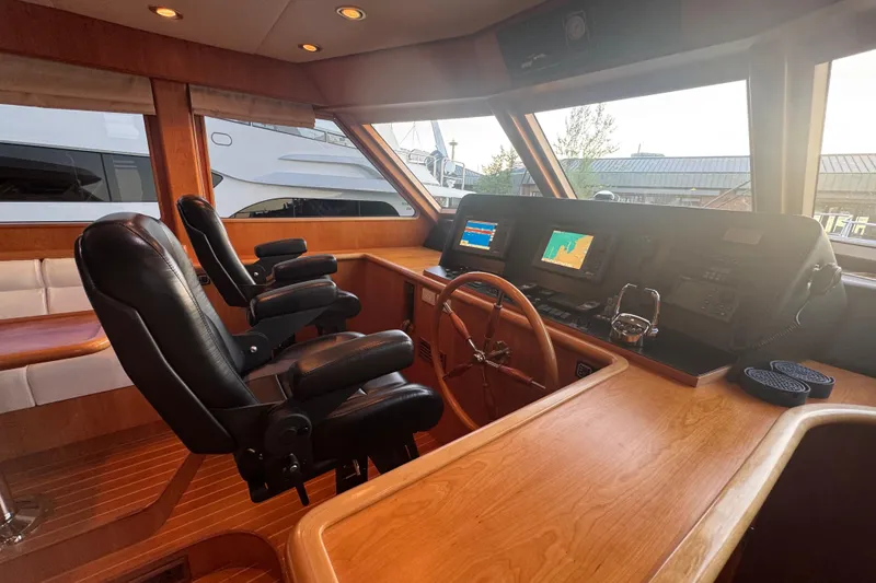 Slide: The Image of Luxurious 2007 Symbol 59' Pilothouse Classic yacht interior with navigation equipment and leather seating. - 22