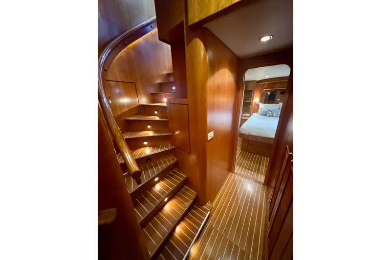 Slide: The Image of Luxurious wooden interior of 2007 Symbol 59' Pilothouse Classic yacht with staircase and bedroom. - 24