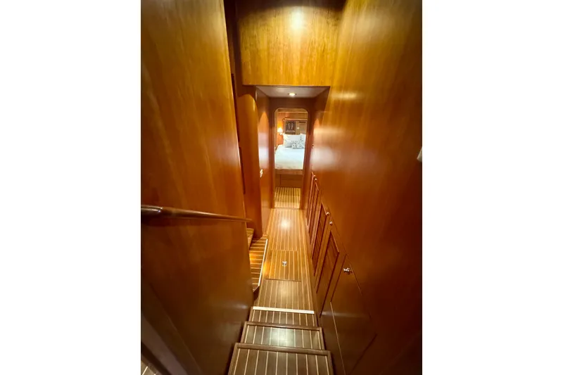 Slide: The Image of Wooden interior staircase of 2007 Symbol 59' Pilothouse Classic yacht, leading to a cozy cabin. - 25