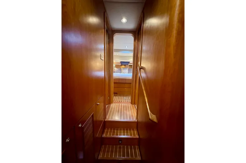 Slide: The Image of Wood-paneled hallway inside 2007 Symbol 59' Pilothouse Classic yacht, leading to a bedroom. - 26