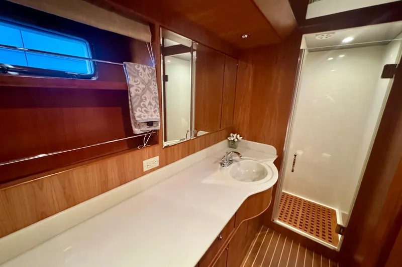 Slide: The Image of Luxurious bathroom in 2007 Symbol 59' Pilothouse Classic yacht with wood accents and modern fixtures. - 29