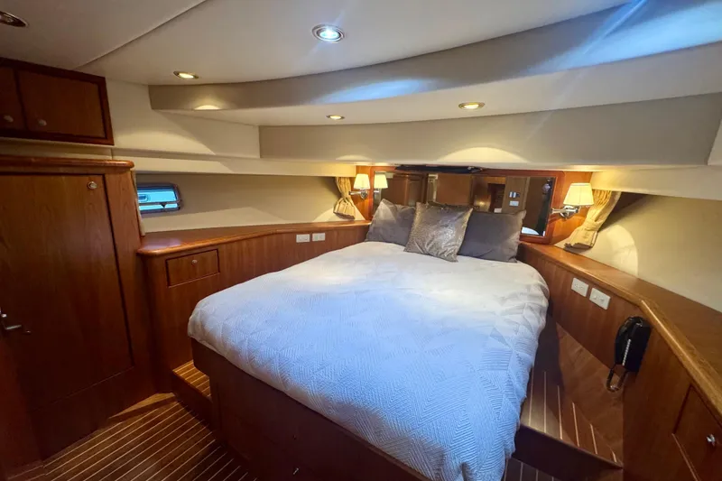 Slide: The Image of Luxurious bedroom interior of 2007 Symbol 59' Pilothouse Classic yacht with cozy bedding. - 30