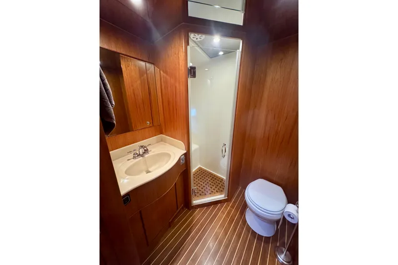 Slide: The Image of Luxurious bathroom in 2007 Symbol 59' Pilothouse Classic yacht with wood accents. - 32