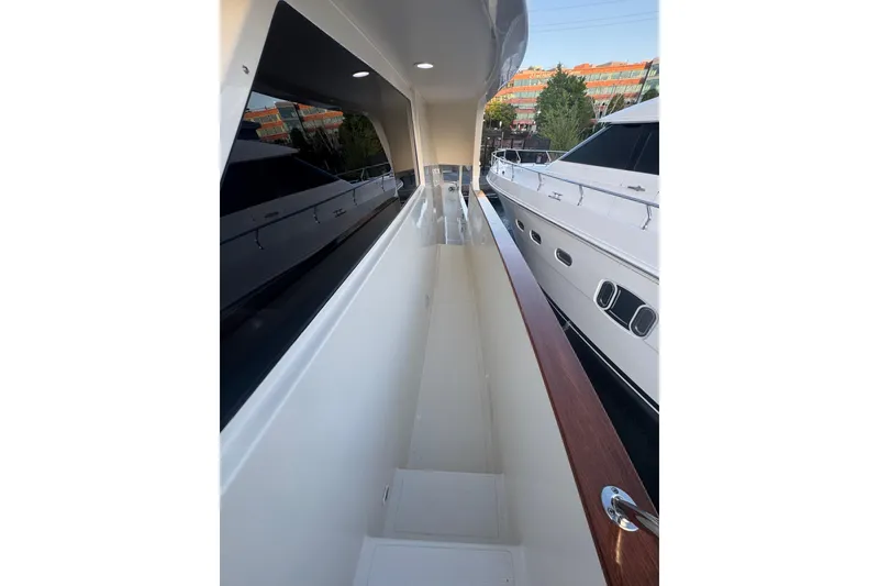Slide: The Image of Side deck view of a 2007 Symbol 59' Pilothouse Classic yacht, showcasing sleek design. - 5