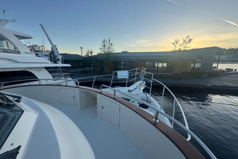 Slide: The Image of 2007 Symbol 59' Pilothouse Classic yacht docked at sunset near modern waterfront building. - 7