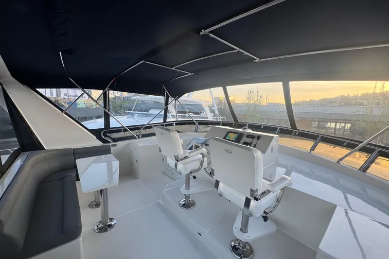 Slide: The Image of Pilothouse interior of 2007 Symbol 59' Pilothouse Classic yacht with helm chairs and panoramic windows. - 9