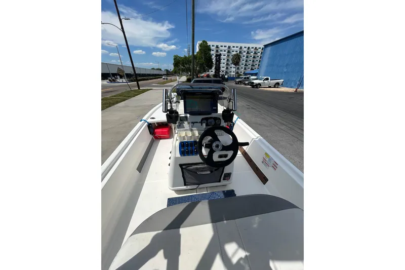 Slide: The Image of 2021 Mako Pro Skiff 19 CC boat interior with steering wheel and dashboard. - 10