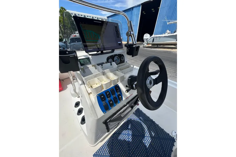 Slide: The Image of 2021 Mako Pro Skiff 19 CC boat console with steering wheel and navigation display. - 12