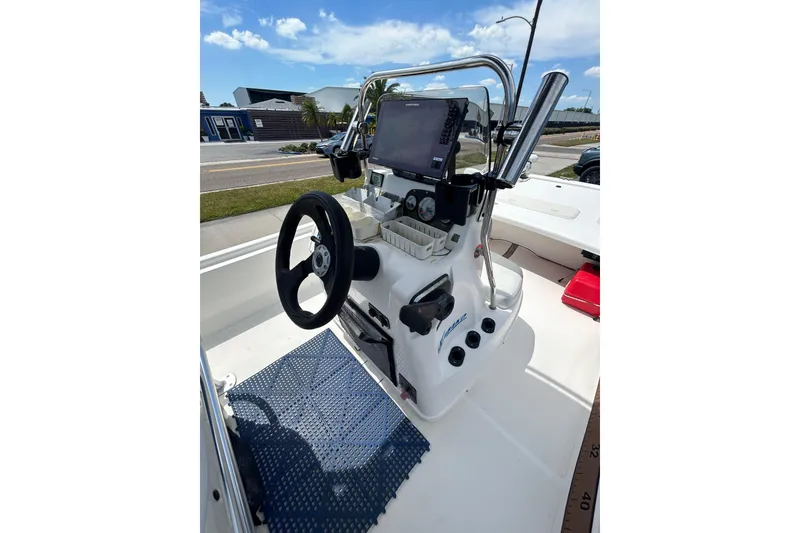 Slide: The Image of 2021 Mako Pro Skiff 19 CC boat console with steering wheel and navigation equipment. - 13