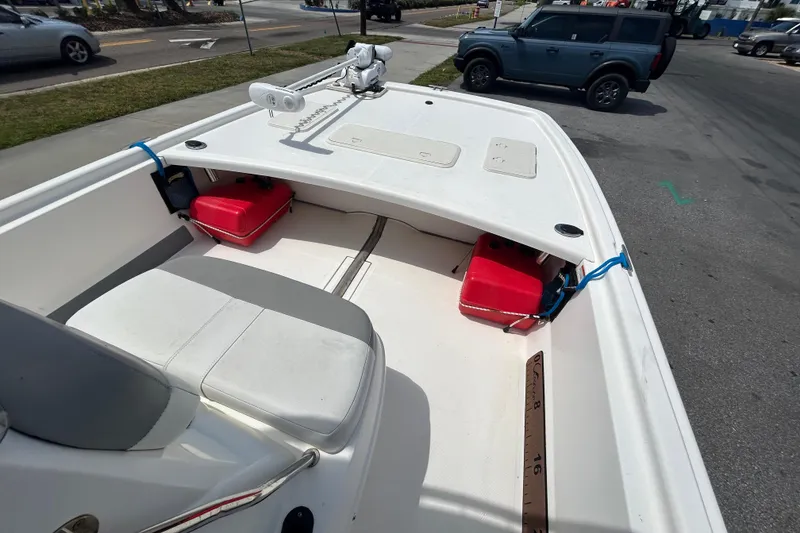 Slide: The Image of 2021 Mako Pro Skiff 19 CC boat interior with seating and storage compartments. - 20
