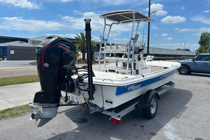 Slide: The Image of 2021 Mako Pro Skiff 19 CC boat with Mercury engine on trailer, parked outdoors. - 3