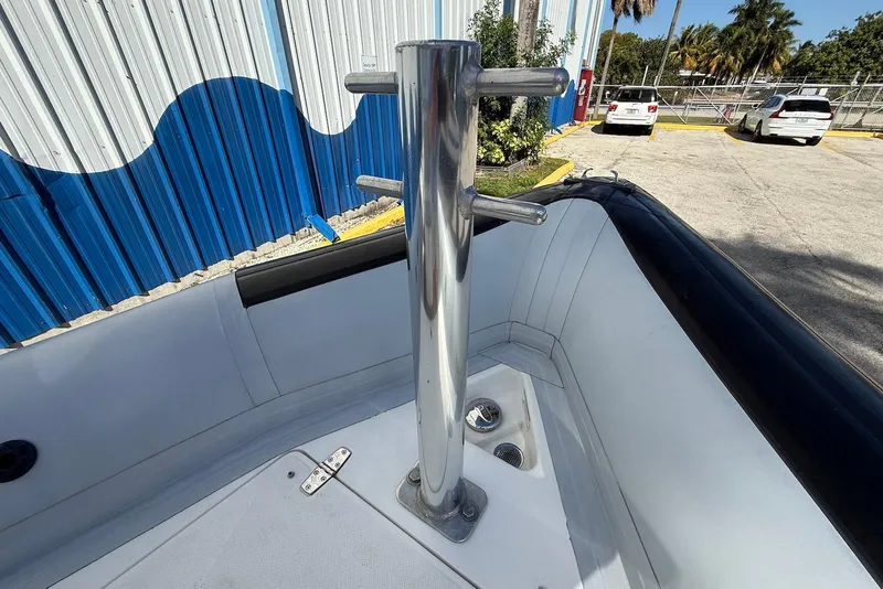 Slide: The Image of Ribcraft 7.8 boat bow with stainless steel bollard, 2018 model, parked near blue building. - 11