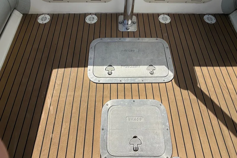 Slide: The Image of Ribcraft 7.8 boat deck, 2018 model, featuring teak flooring and metal hatches. - 13
