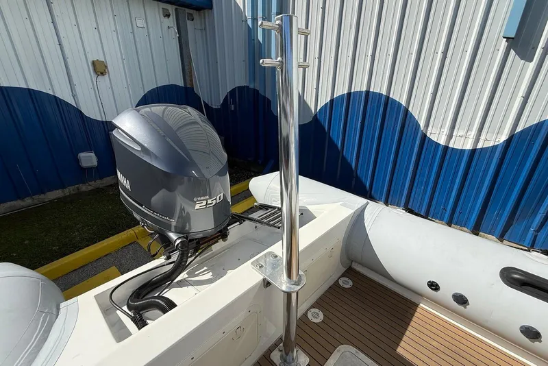 Slide: The Image of 2018 Ribcraft 7.8 boat with Yamaha 250 engine, docked near blue and white building. - 14