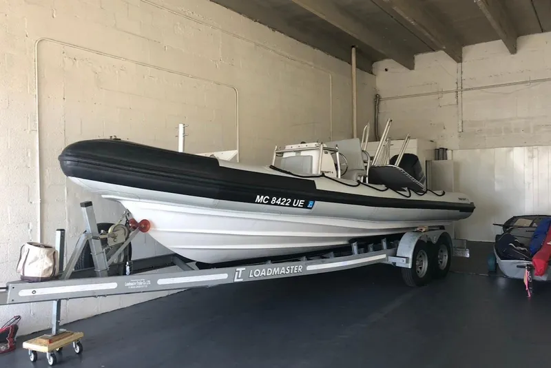 Slide: The Image of 2018 Ribcraft 7.8 boat on Loadmaster trailer in indoor storage. - 17