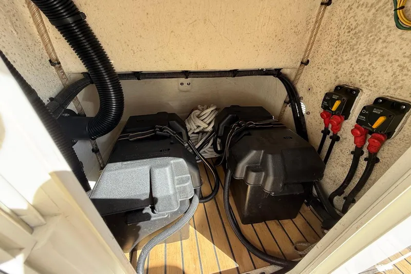 Slide: The Image of Battery compartment of a 2018 Ribcraft 7.8 boat with wiring and switches. - 19
