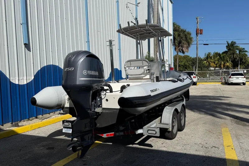 Slide: The Image of 2018 Ribcraft 7.8 boat with Yamaha 250 engine on a trailer, parked outdoors. - 4