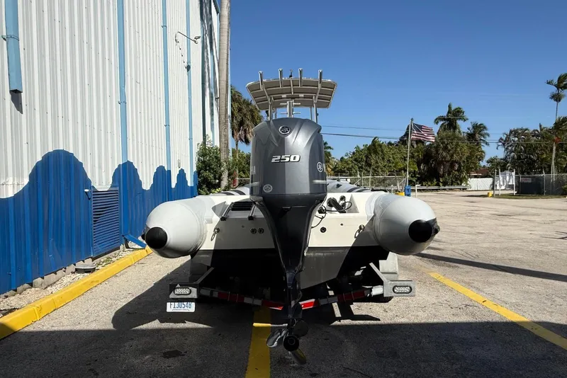 Slide: The Image of 2018 Ribcraft 7.8 boat with Yamaha 250 engine on trailer, parked outdoors. - 5