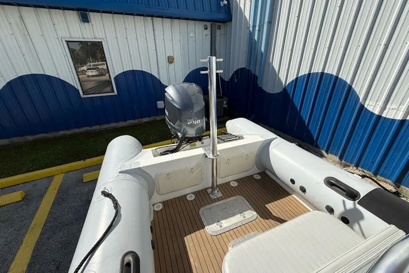 Slide: The Image of 2018 Ribcraft 7.8 boat with Yamaha 250 engine, docked near blue and white building. - 6