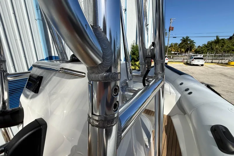 Slide: The Image of 2018 Ribcraft 7.8 boat with stainless steel railings and inflatable sides in a sunny marina. - 8