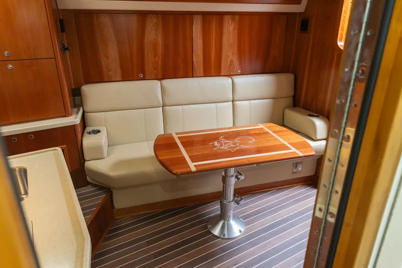 Slide: The Image of Interior of 2022 Albemarle 36 Express with leather sofa and wooden table. - 32