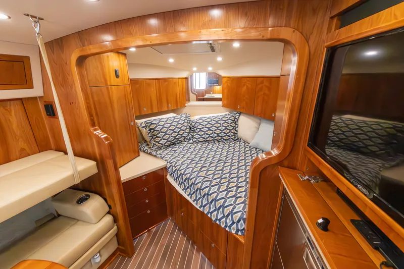 Slide: The Image of Interior of 2022 Albemarle 36 Express with cozy bed and wood finish. - 42