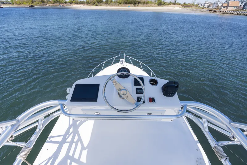 Slide: The Image of Helm of 2022 Albemarle 36 Express on calm waters. - 47