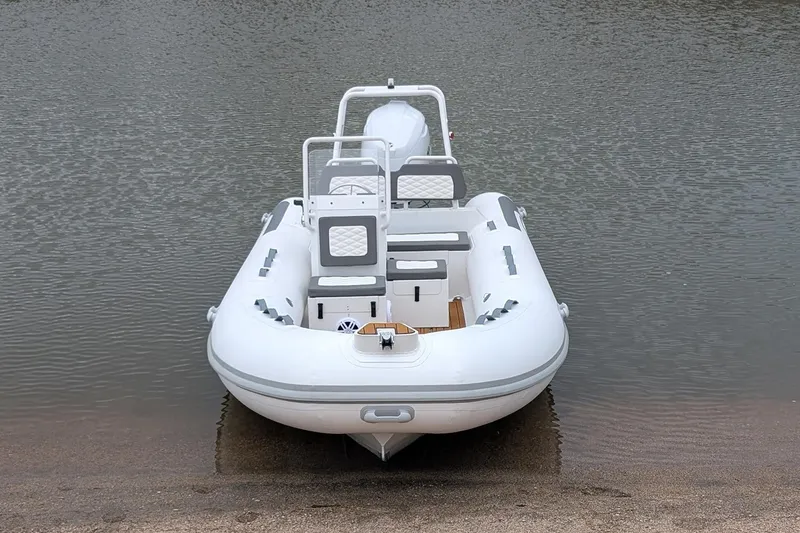 Slide: The Image of Manufacturer Provided Image: 2025 Tide Craft Kodiak 16 inflatable boat on calm water, front view. - 2