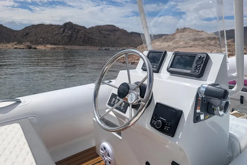 Slide: The Image of Manufacturer Provided Image: 2025 Tide Craft Kodiak 16 boat dashboard with steering wheel and navigation equipment. - 4
