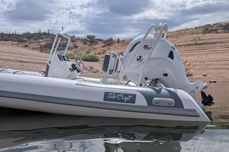 Slide: The Image of Manufacturer Provided Image: 2025 Tide Craft Kodiak 16 boat on calm water, showcasing sleek design and powerful engine. - 5