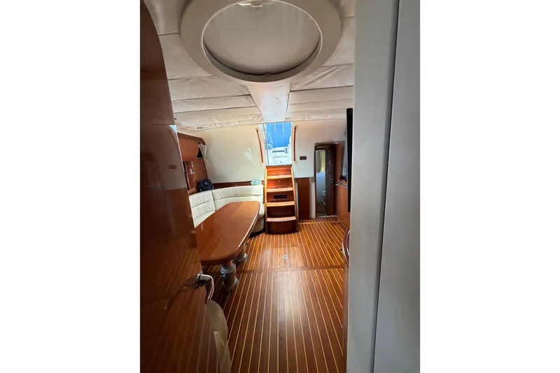 Slide: The Image of Interior of 2003 Viking Princess V50 yacht with wooden flooring and elegant seating area. - 11