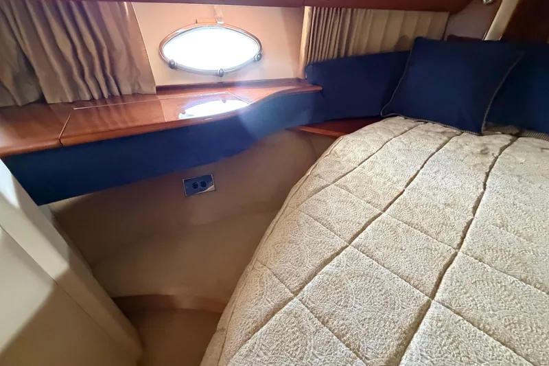 Slide: The Image of Cozy cabin interior of 2003 Viking Princess V50 yacht with elegant bedding and porthole. - 12